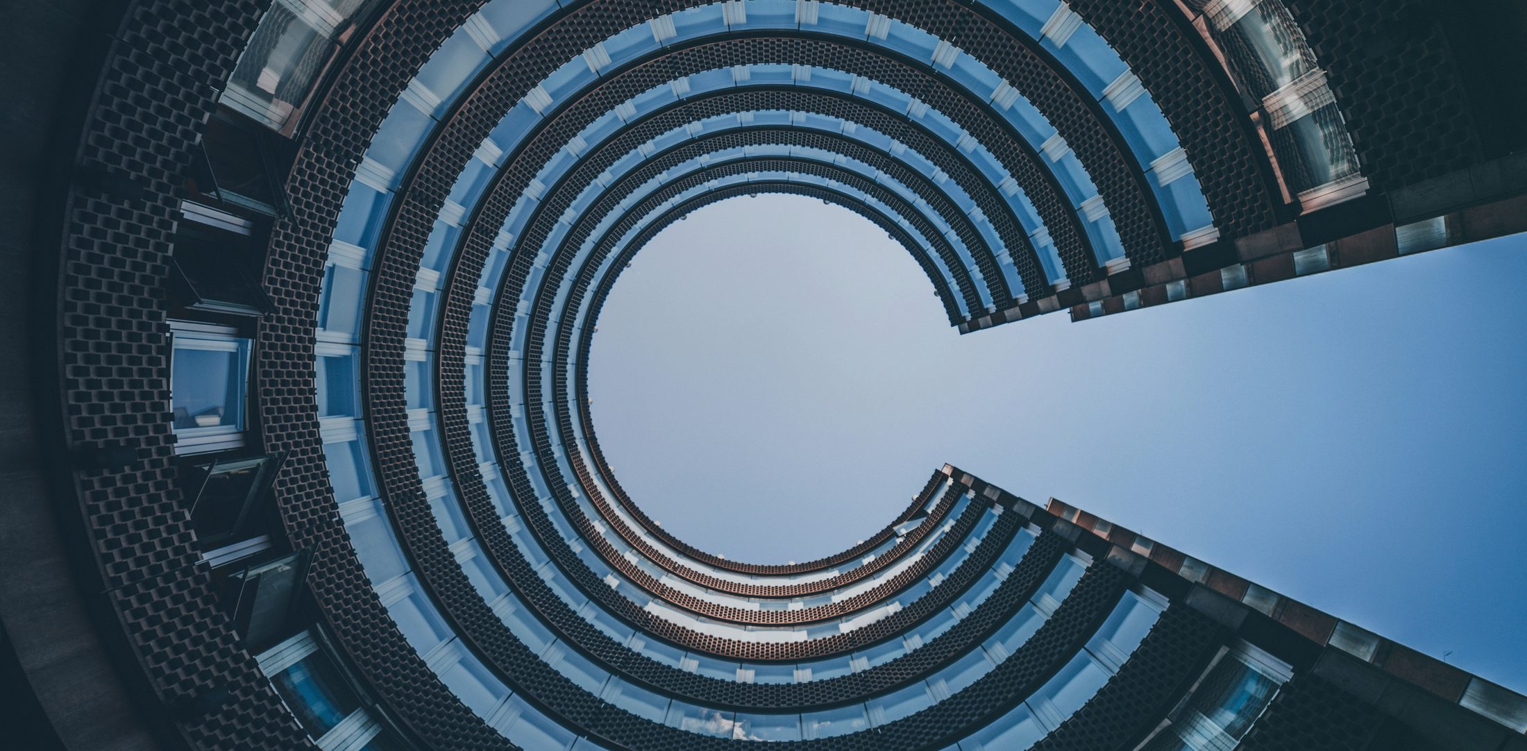 Looking up at a curved office building