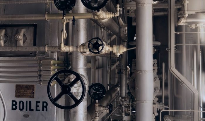 Industrial boiler control panel with pressure gauges and valve wheels
