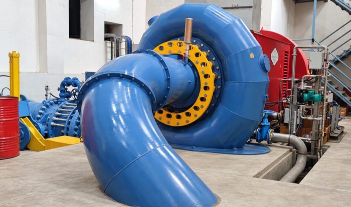 Industrial turbine room with blue governor-controlled unit assembly